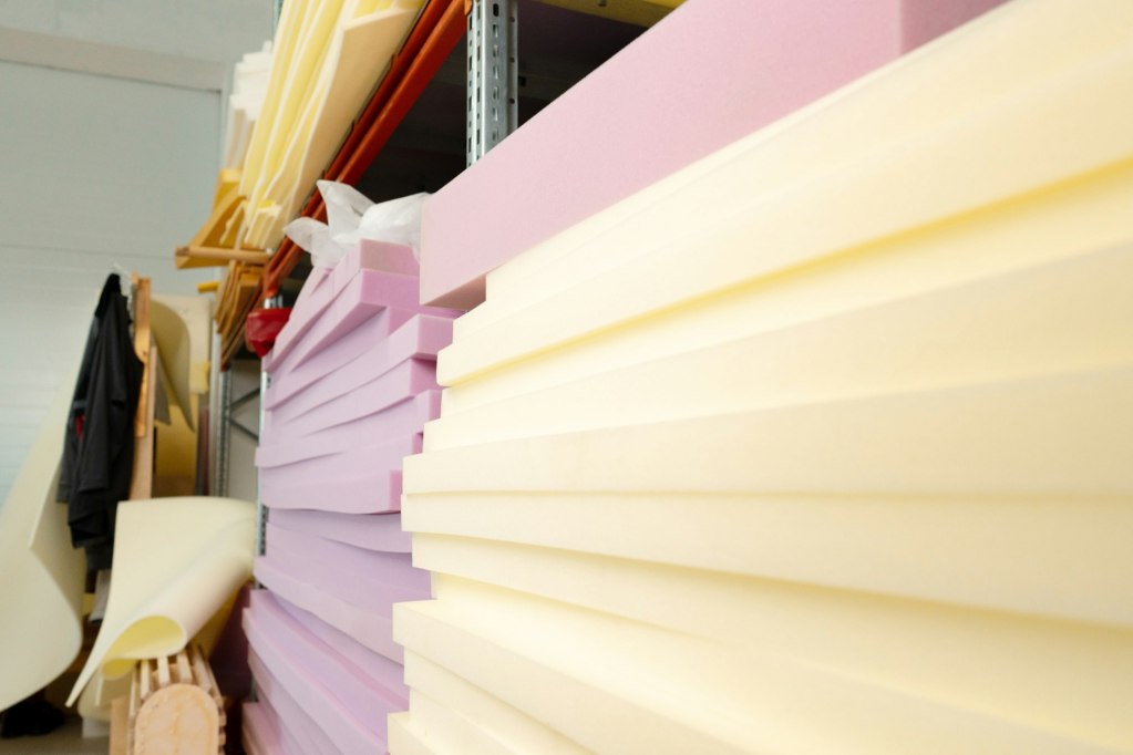 Stacked sheets of foam rubber for furniture production in factory workshop